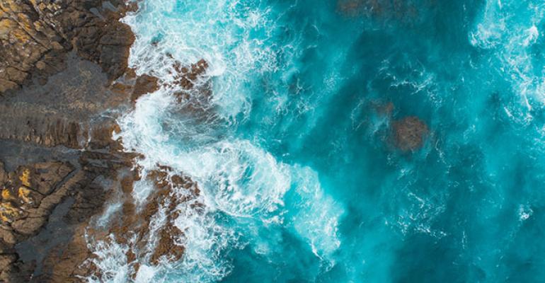 Aerial-view-of-waves-splashing-on-beach_650x450.jpg