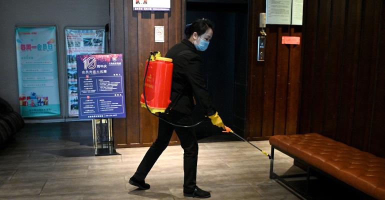 A staff disinfects the lobby of a hotel in Jiujiang in China's central Jiangxi province. 