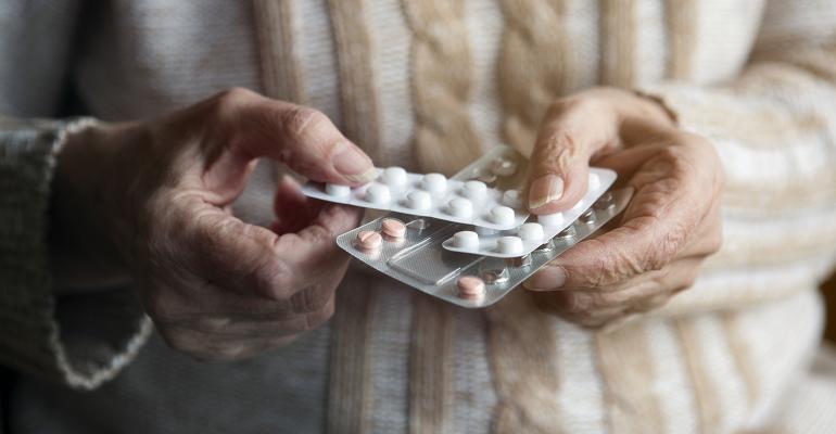 elderly woman hands pills