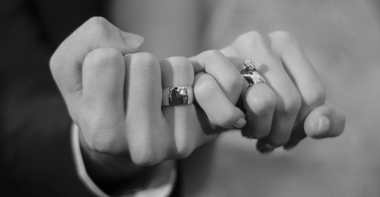 holding hands wedding rings