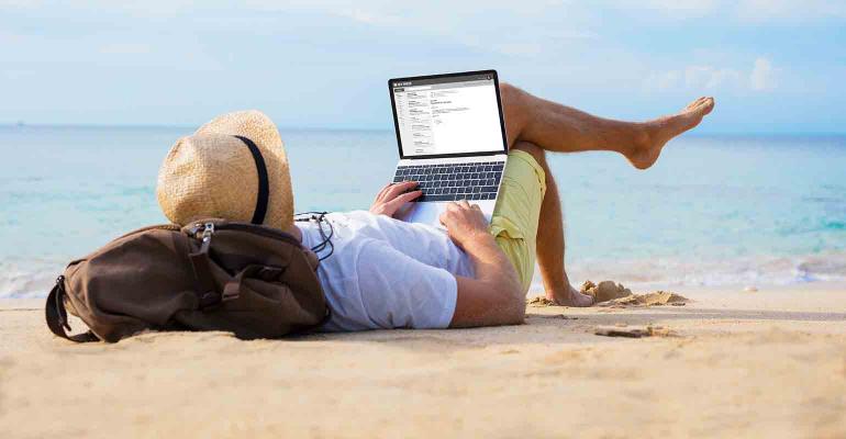 man-reading-laptop-beach.jpg