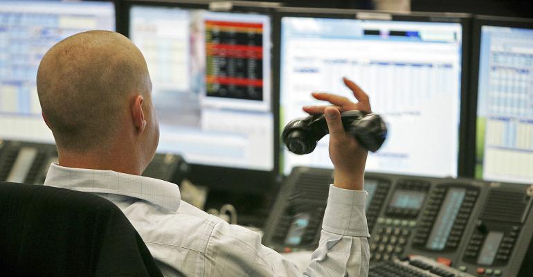 stock trader holding phone