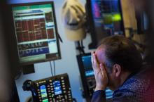 stock market trader hands on face