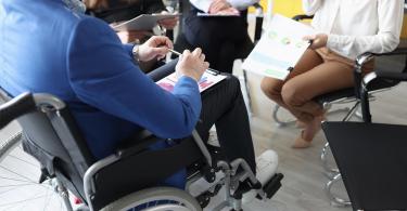 man in wheelchair having conversation special needs planning