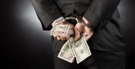 businessman handcuffs money