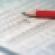 financial documents red pencil debt