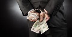 businessman handcuffs money