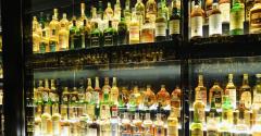 whiskey bottles in cabinet alternative investments