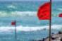 red warning flags on beach
