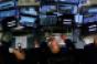 stock market trader crowded desk screens monitors